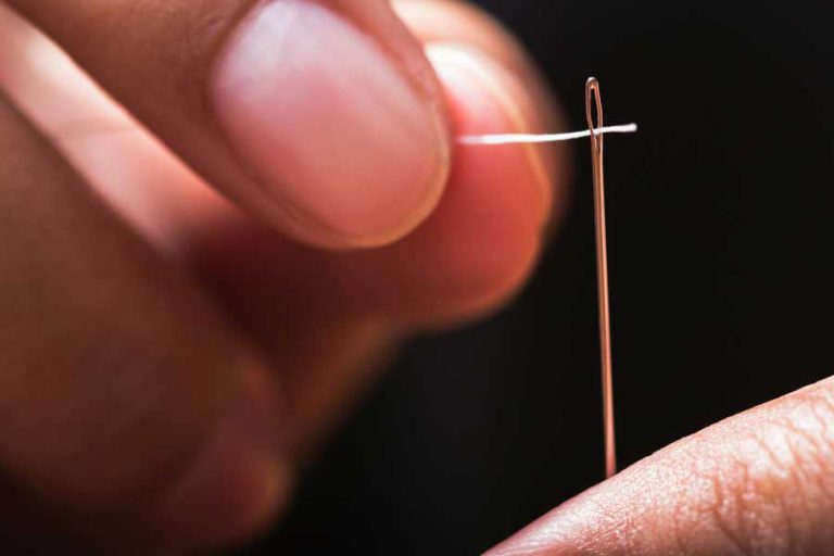 close up image of needle being threaded