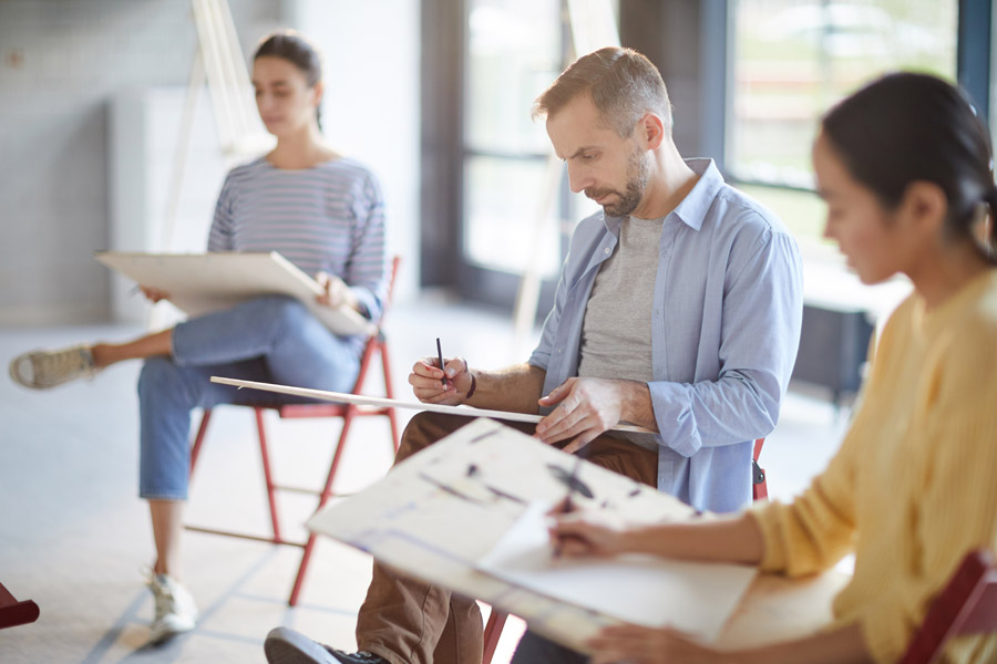 People siting and drawing